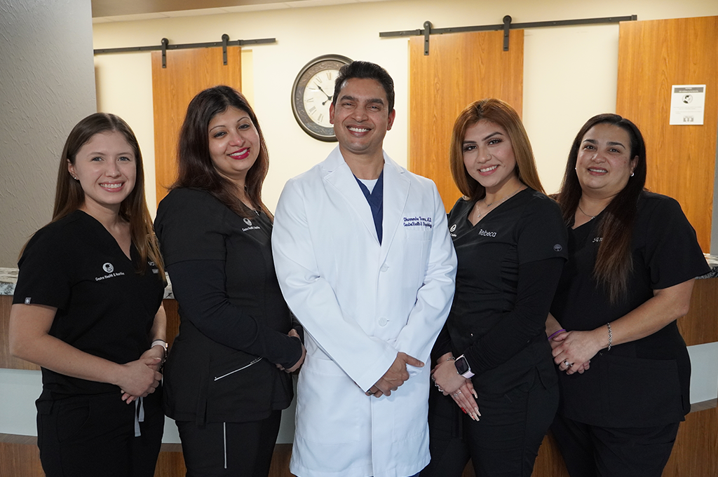 Group photo of medical professionals at Gastro Health & Nutrition clinic, including a doctor and staff members smiling at the camera.