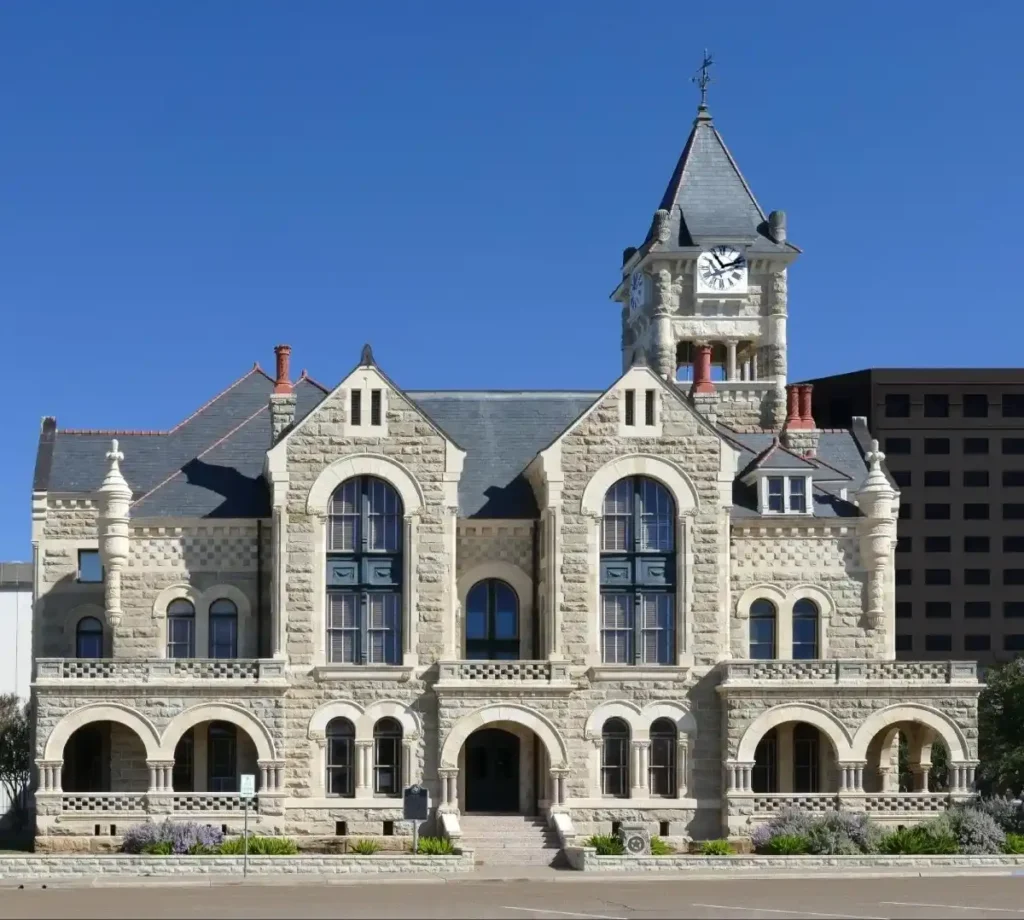 A beautiful view of a historic courthouse building with a clock tower in the heart of the city.